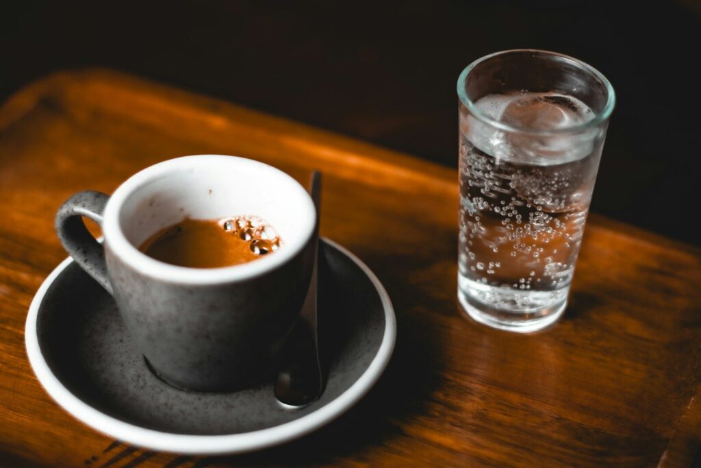 A cup of tea and a glass of water on a table