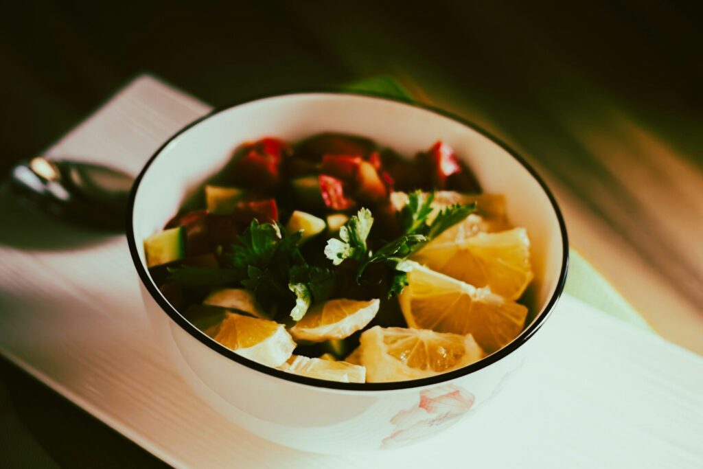 a white bowl filled with fruit on top of a table